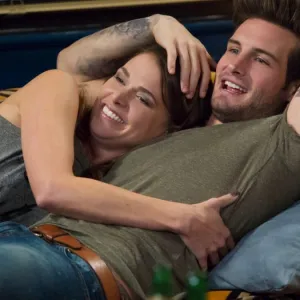 A man and a woman lie next to each other in 'Younger.'