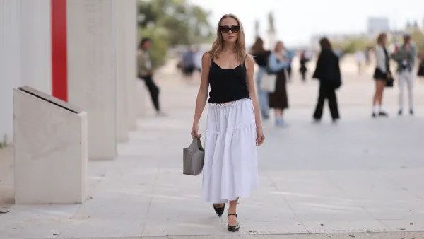 PARIS, FRANCE - SEPTEMBER 28: Guest is seen outside Chloe show wearing black sunnies, black tank top, white ruffled long skirt, taupe colored handbag and black leather ballet flats during the Womenswear Spring/Summer 2024 as part of Paris Fashion Week on September 28, 2023 in Paris, France. (Photo by Jeremy Moeller/Getty Images)