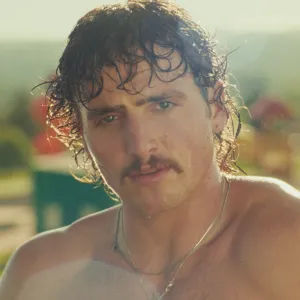 Benson Boone shirtless in his "Mr. Electric Blue" music video