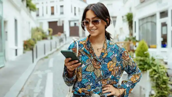 Fashionable millennial woman with sunglasses in city of Paris - stock photo