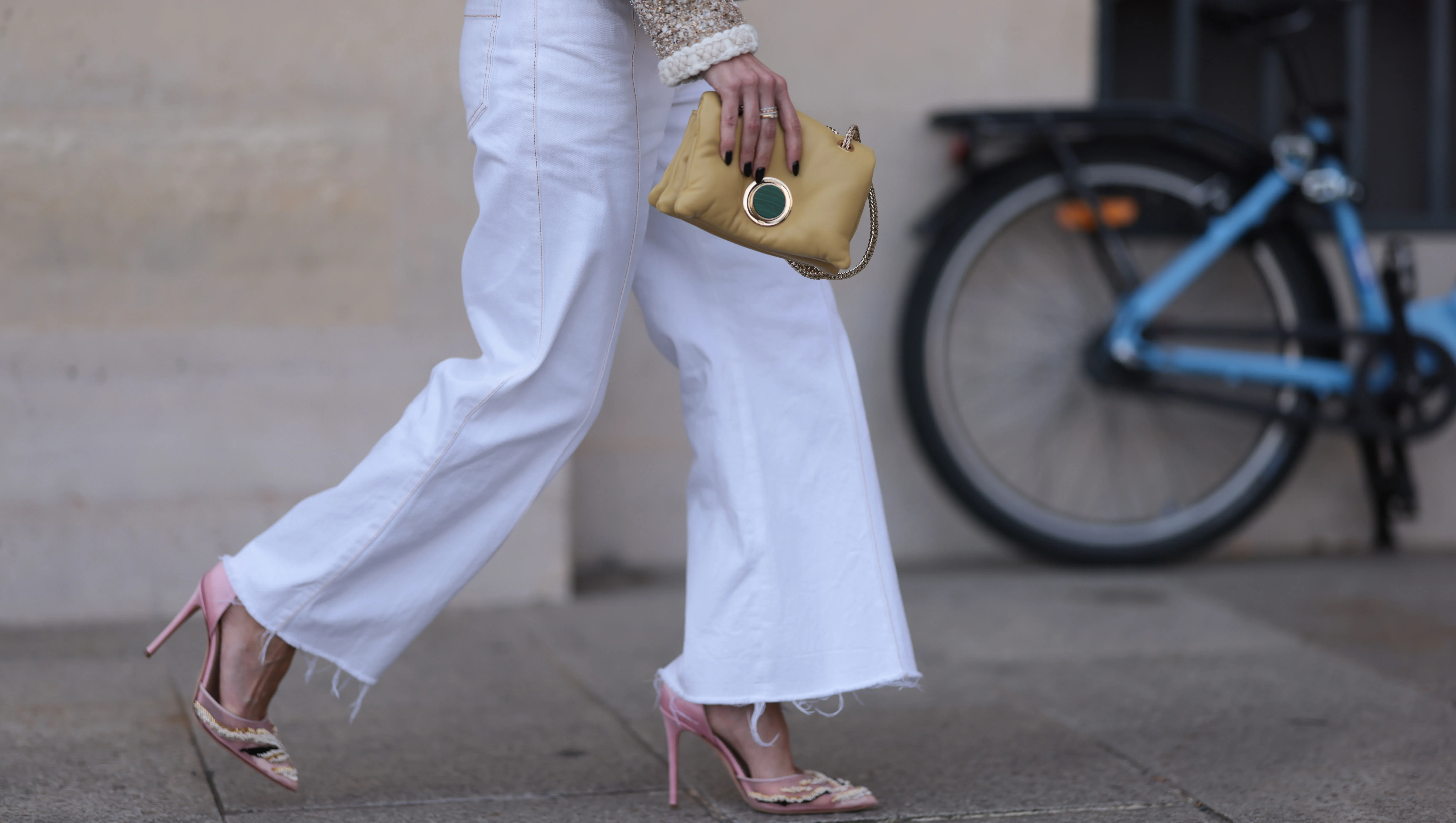 PARIS, FRANCE - SEPTEMBER 29: A guest seen wearing a beige/white jacket with silver button details, a straight leg white pants, a yellow bag and rose pointed shoes with white details, outside the Giambattista Valli Show during the Womenswear Spring/Summer 2024 as part of Paris Fashion Week on September 29, 2023 in Paris, France. (Photo by Jeremy Moeller/Getty Images)