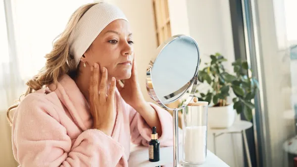 Beautiful woman taking care of her skin - stock photo
