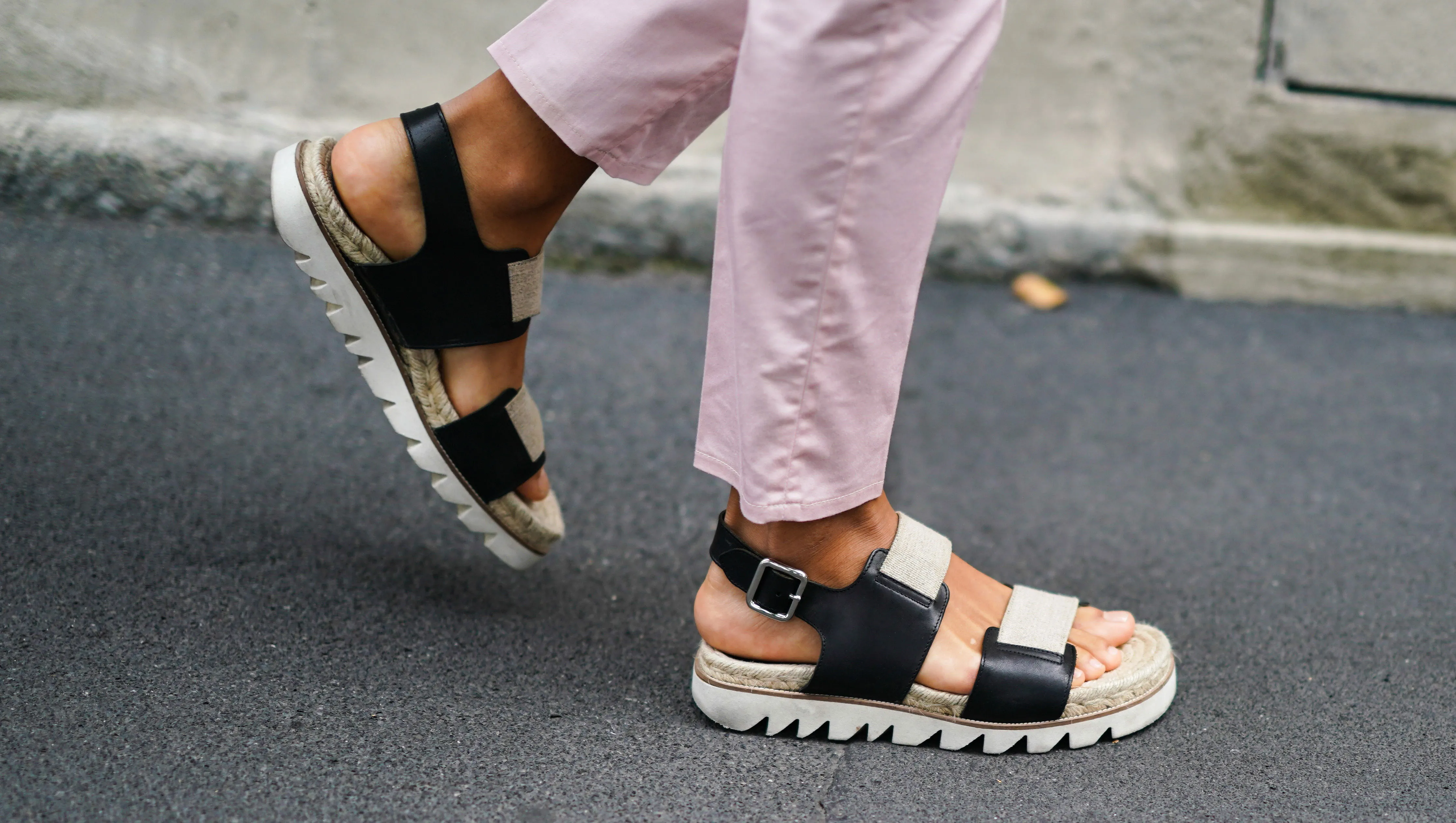 MILAN, ITALY - SEPTEMBER 18: A guest wears light pink pants, black and beige flat sandals, outside the Prada show during Milan Fashion Week Spring/Summer 2020 on September 18, 2019 in Milan, Italy. (Photo by Edward Berthelot/Getty Images)