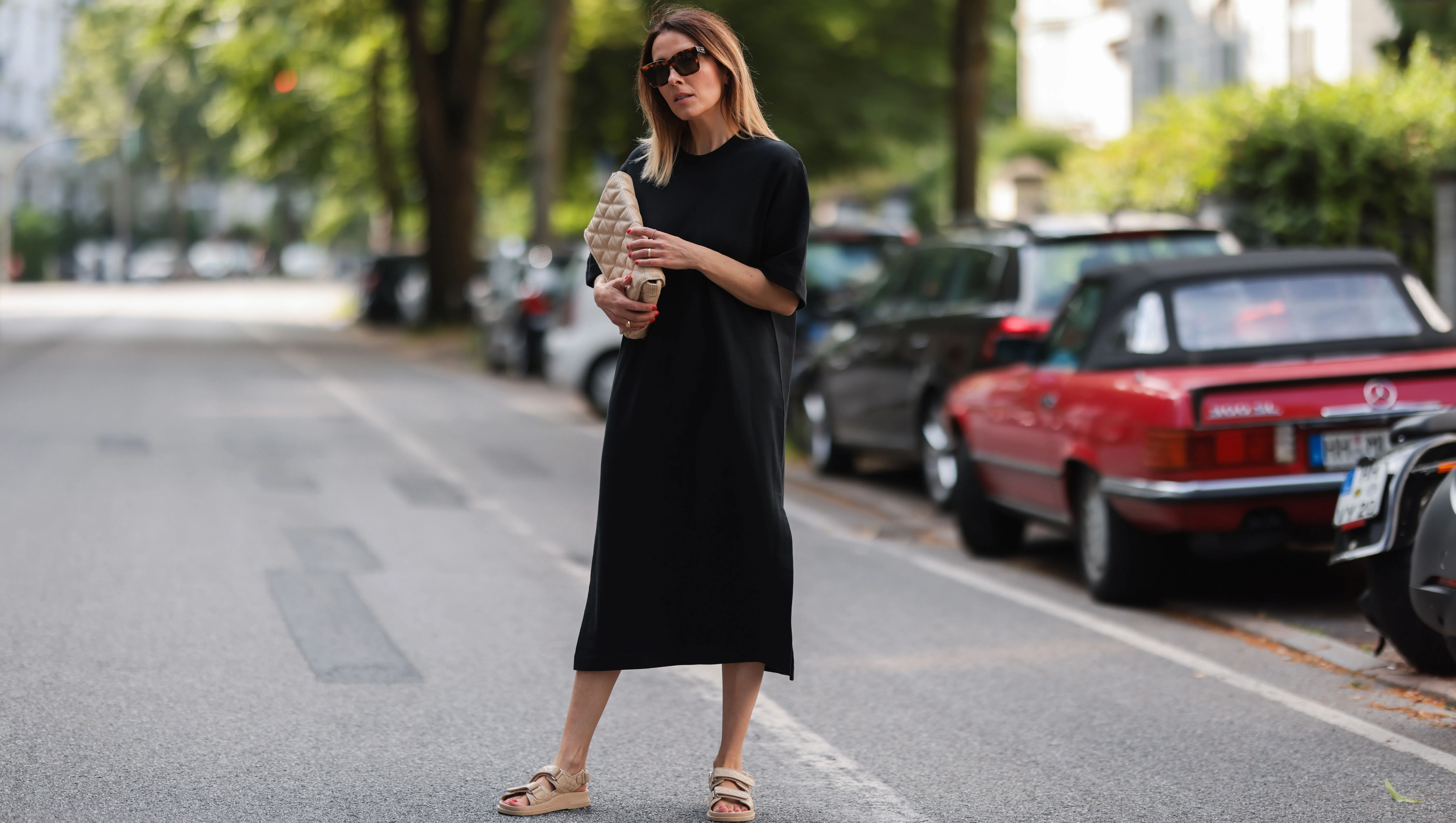 HAMBURG, GERMANY - JUNE 26: Elise Soho wearing Bruna the Label jewelry, beige Zara bag, beige Ducie London sandals and black Soho Studios midi dress on June 26, 2021 in Hamburg, Germany. (Photo by Jeremy Moeller/Getty Images)