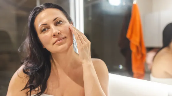 Woman Applying Face Cream - stock photo
