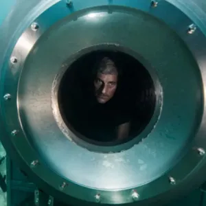 A man looks out on the ocean in Titan: The OceanGate Disaster