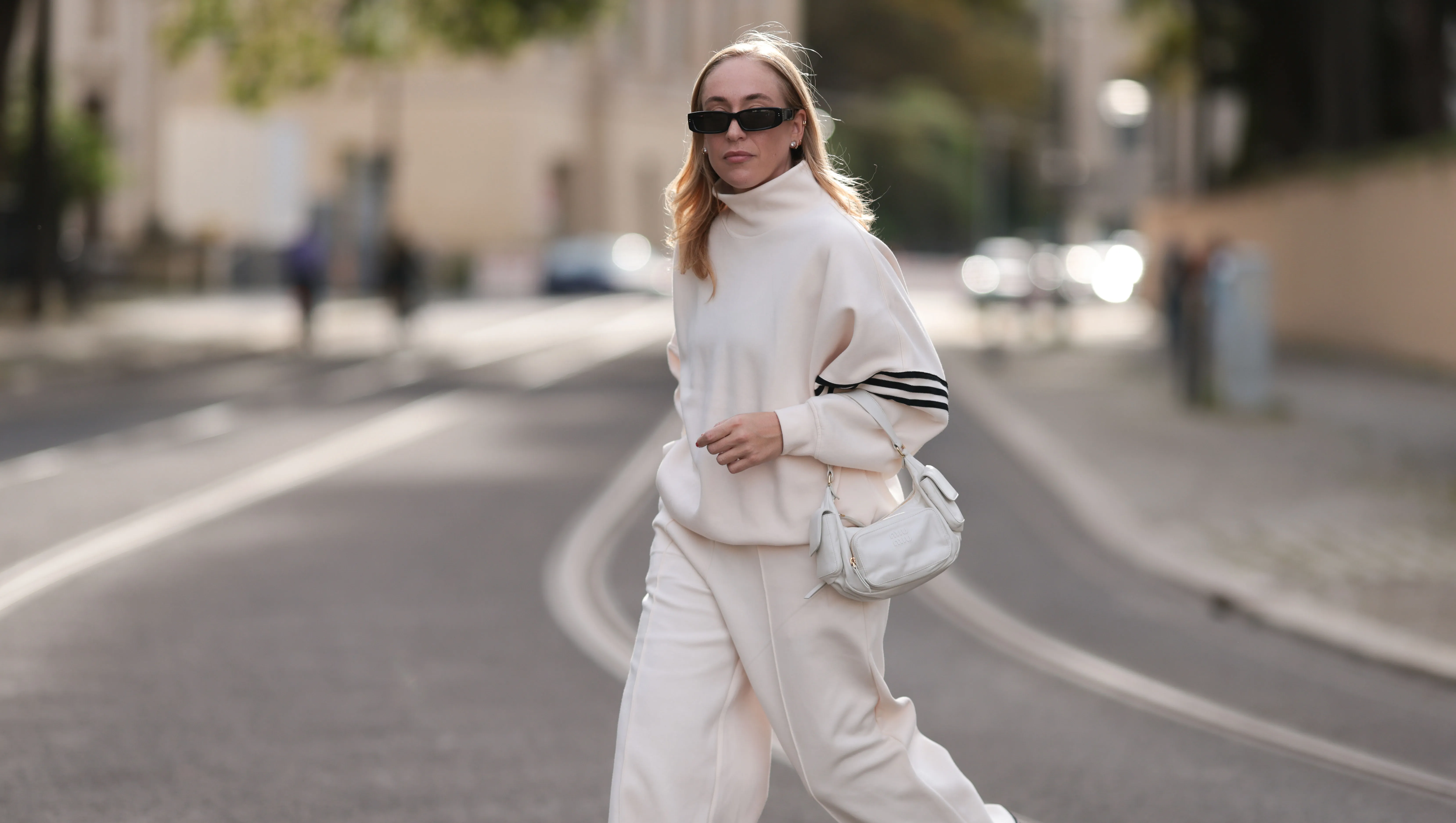 Sonia Lyson seen wearing Linda Farrow black sunglasses, Adidas white two-piece / white logo cotton oversized sweater and matching white wide leg pants, Miu Miu white leather Pocket bag, Copenhagen Studios white with black details leather sneakers, on September 03, 2023 in Berlin, Germany. (Photo by Jeremy Moeller/Getty Images)