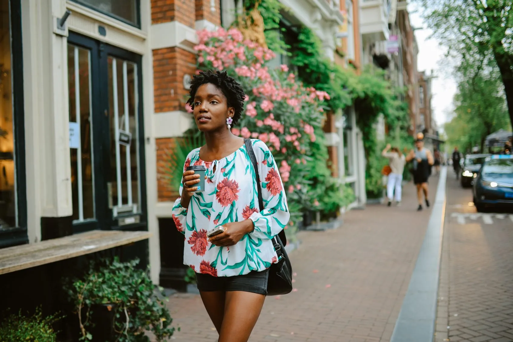 Amsterdam city lifestyle. Young woman walks the streets, casually exploring the city or going to meet her friends for a coffee. Travel and urban lifestyle concepts.
