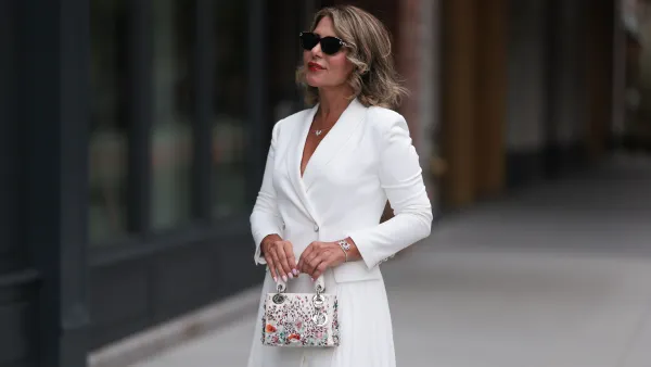 NEW YORK, NEW YORK - SEPTEMBER 07: Olga Ferrara seen wearing diamond studded black sunglasses, Leibish diamond necklace and bracelet, Milly white elegant blazer short dress and Dior white leather / colorful rhinestones pattern embroidered handbag, during the New York Fashion Week, on September 07, 2024 in New York City. (Photo by Jeremy Moeller/Getty Images)