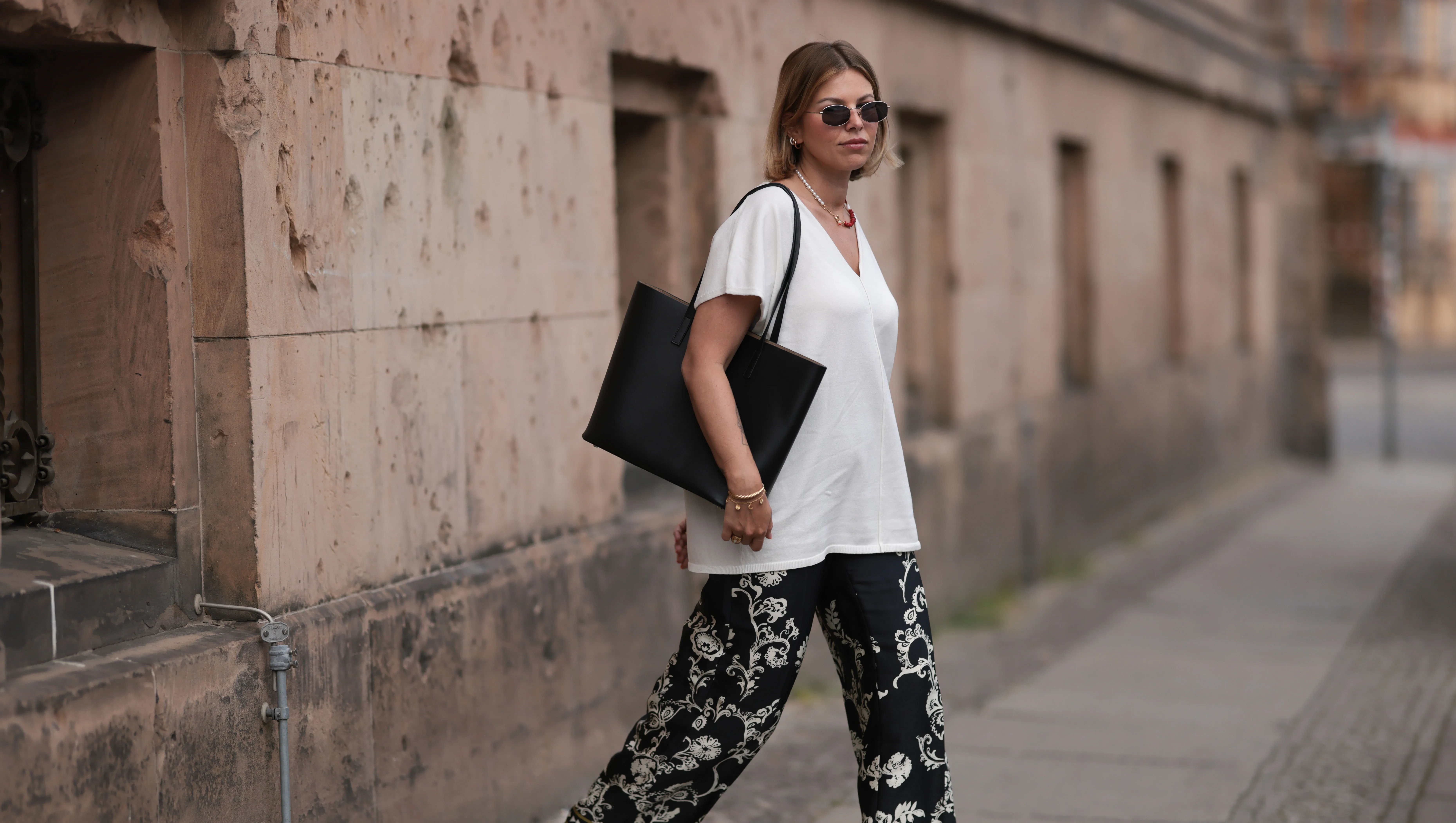 BERLIN, GERMANY - JUNE 06: Aline Kaplan wearing Zara black and white wide leg pattern pants, white Zara shirt, Marc Jacobs round silver shades and Agneel black leather bag on June 06, 2023 in Berlin, Germany. (Photo by Jeremy Moeller/Getty Images)
