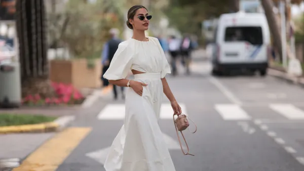 CANNES, FRANCE - MAY 21: Jessica de Oliviera seen wearing Dior black sunglasses, Dior bag, Chanel heels, Rolex yellow gold watch and a flowy long dress with cutouts during the 76th Cannes film festival on May 21, 2023 in Cannes, France. (Photo by Jeremy Moeller/Getty Images)