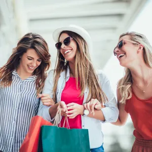 Beautiful woman with shopping bags in the city-sale, shopping, tourism and happy people concept
