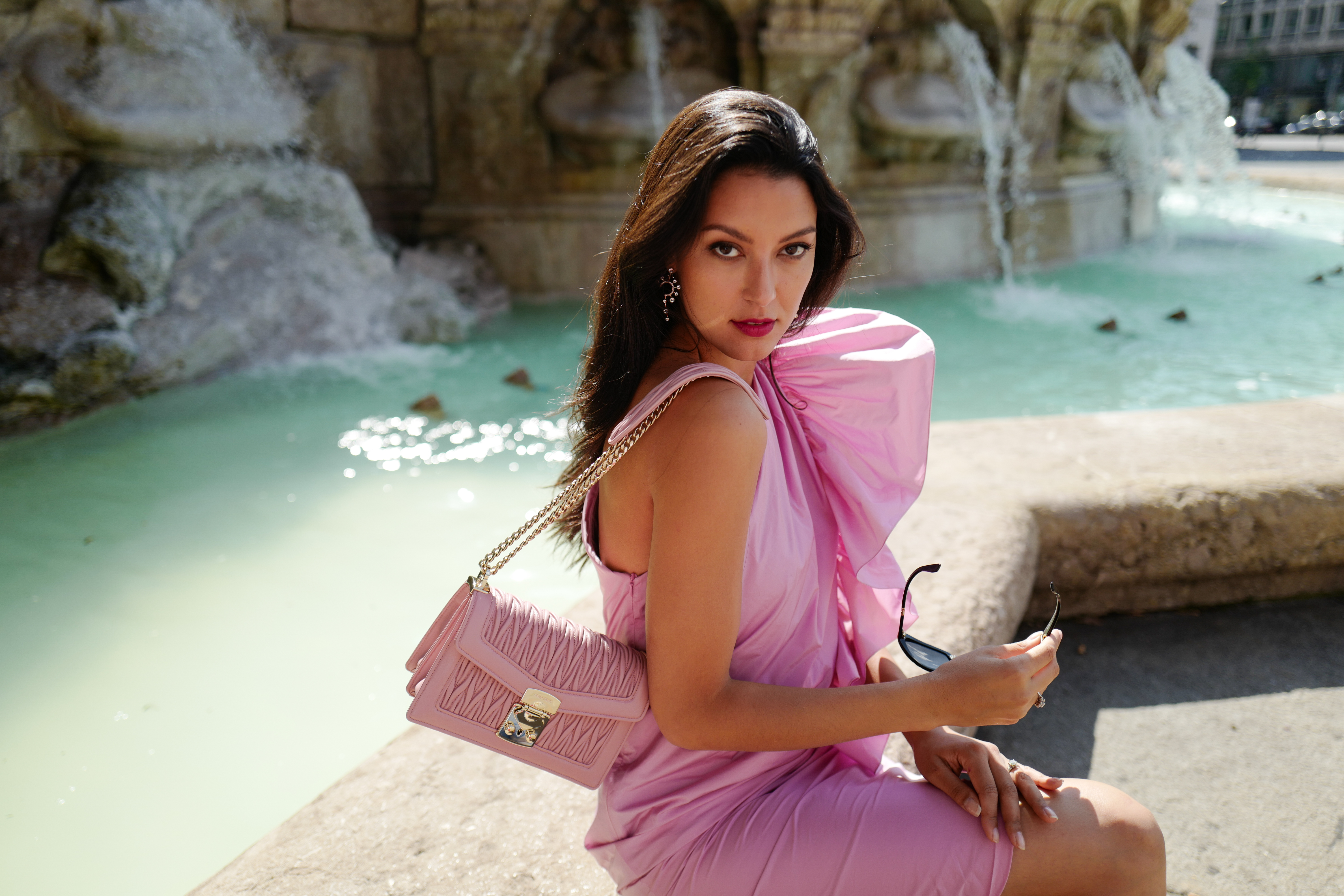 Rebecca Mir wearing Miu Miu shades and bag, Atelier Swarovski earrings and Max Mara dress on July 21, 2020 in Munich, Germany.