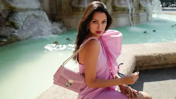 Rebecca Mir wearing Miu Miu shades and bag, Atelier Swarovski earrings and Max Mara dress on July 21, 2020 in Munich, Germany.