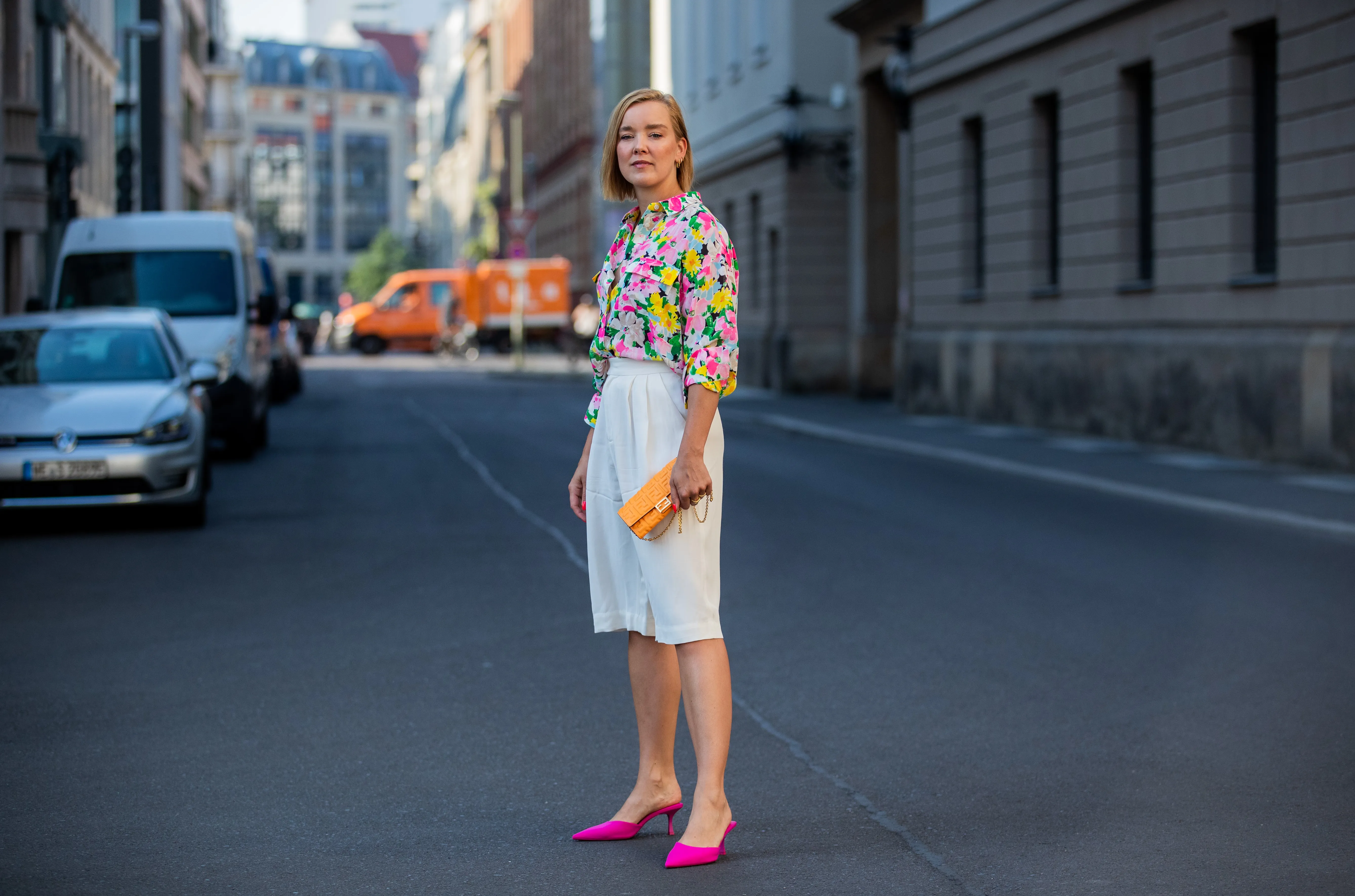 Tina Haase is seen wearing white Bermuda shorts &other stories, Essentiel Antwerp blouse with floral print, orange Fendi bag, pink Zara he on June 21, 2021 in Berlin, Germany.