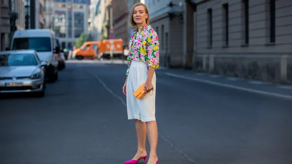 Tina Haase is seen wearing white Bermuda shorts &other stories, Essentiel Antwerp blouse with floral print, orange Fendi bag, pink Zara he on June 21, 2021 in Berlin, Germany.