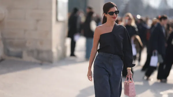 Gilda Ambrosio is seen wearing a black oneshoulder top, grey denim pants, pink Dior bag, black sunglasses outside Christian Dior during the Womenswear Fall/Winter 2024/2025 as part of Paris Fashion Week on February 27, 2024 in Paris, France.