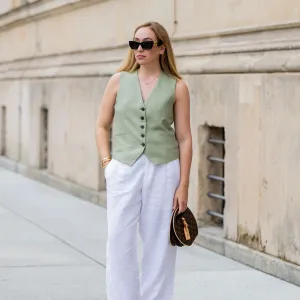 BERLIN, GERMANY - JULY 01: Sonia Lyson wears pink black Chanel ballerinas, white linen pants & green vest Zara, Louis Vuitton bag, sunglasses Miu Miu during the Berlin Fashion Week SS25 on July 01, 2024 in Berlin, Germany. (Photo by Christian Vierig/Getty Images)
