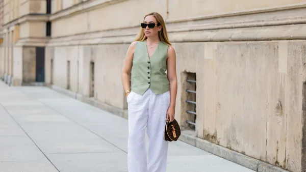 BERLIN, GERMANY - JULY 01: Sonia Lyson wears pink black Chanel ballerinas, white linen pants & green vest Zara, Louis Vuitton bag, sunglasses Miu Miu during the Berlin Fashion Week SS25 on July 01, 2024 in Berlin, Germany. (Photo by Christian Vierig/Getty Images)