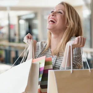 Mixed race woman carrying shopping bags in mall