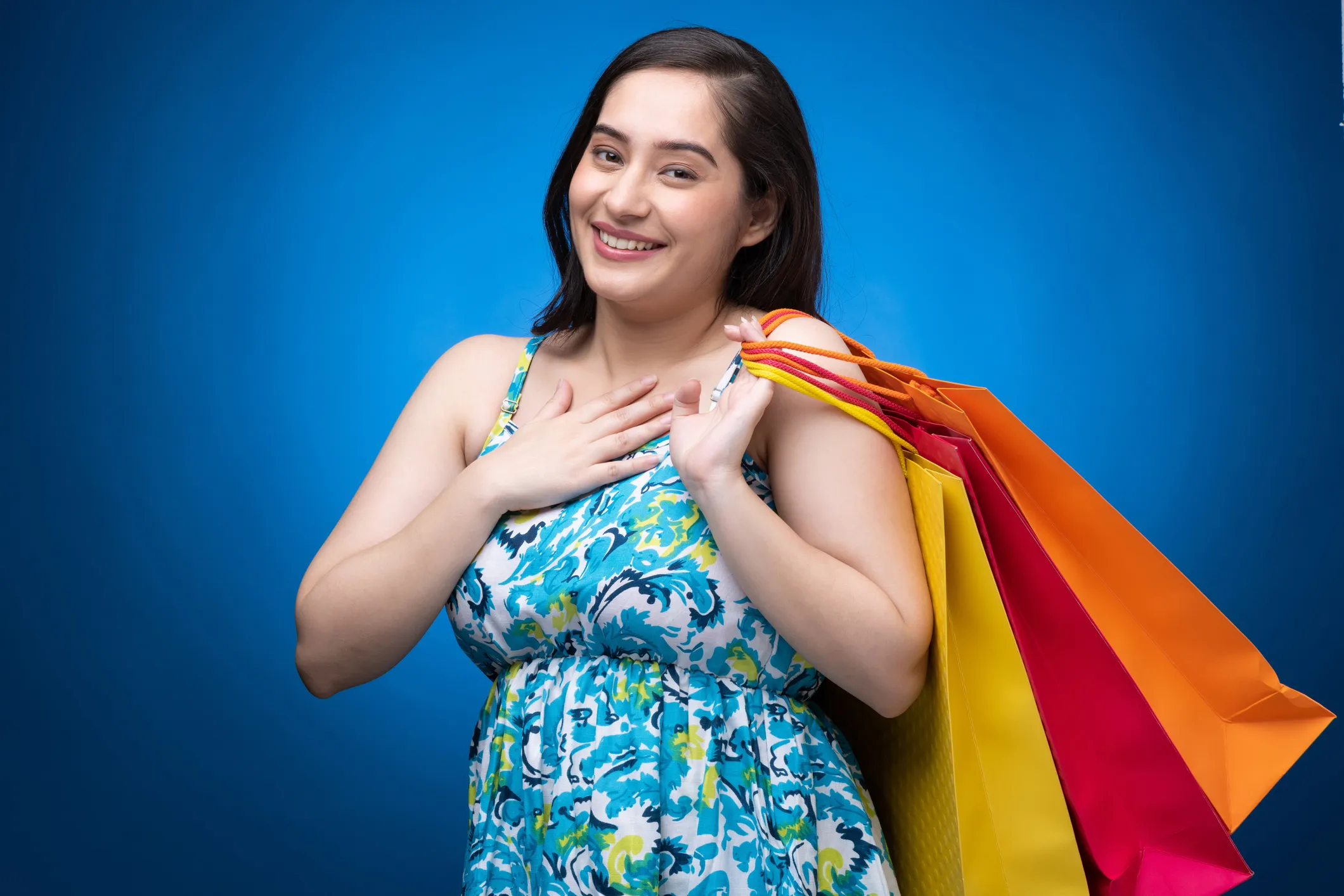 Portrait of young woman wear dress isolated on blue background