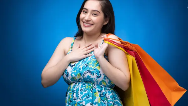 Portrait of young woman wear dress isolated on blue background