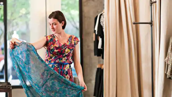 Woman in a floral dress admires another floral dress