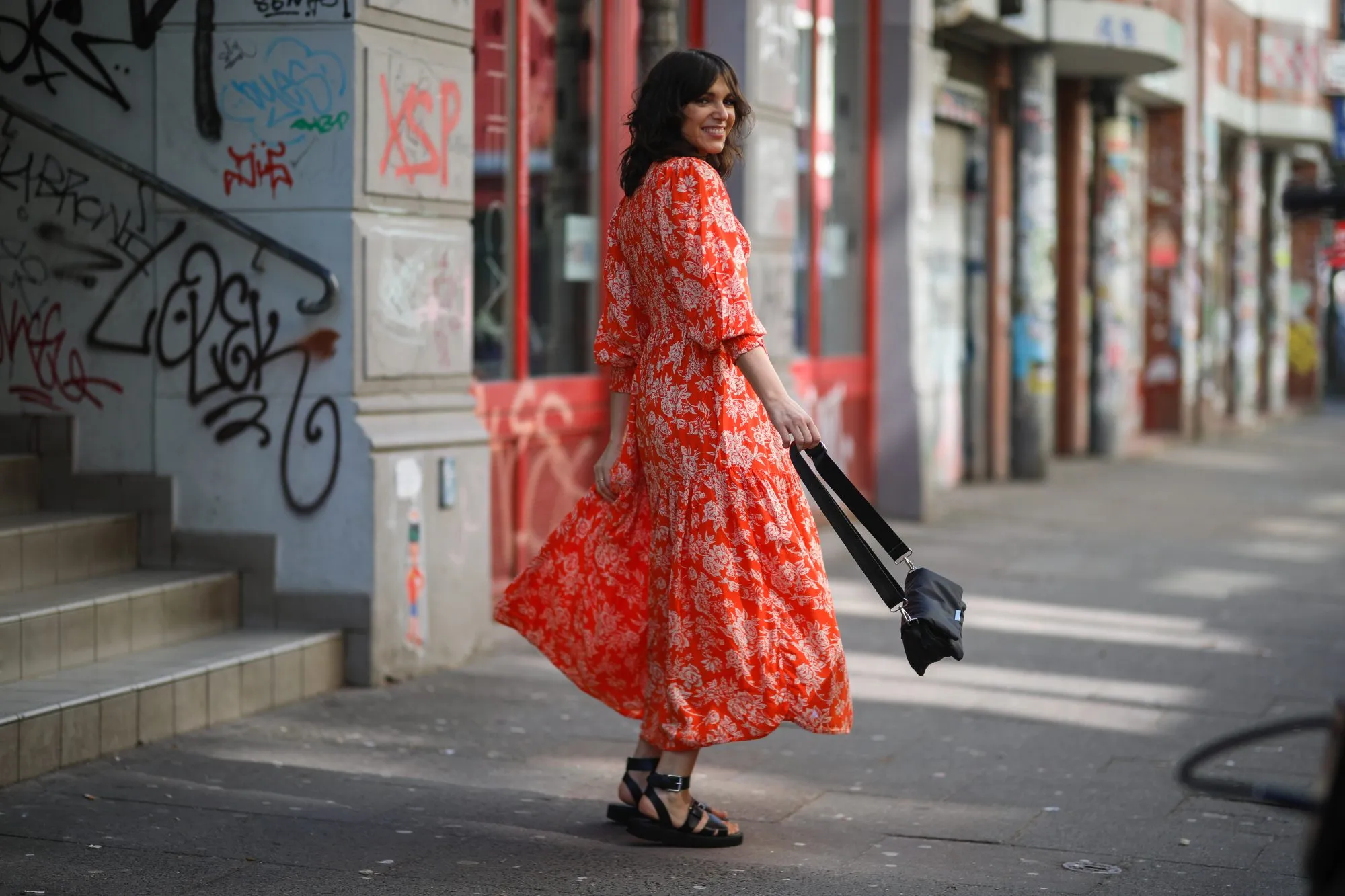 HAMBURG, GERMANY - MARCH 30: Anna Wolfers poses wearing red floral midi dress, black bag and black open toe sandals on March 30, 2021 in Hamburg, Germany. (Photo by Jeremy Moeller/Getty Images)