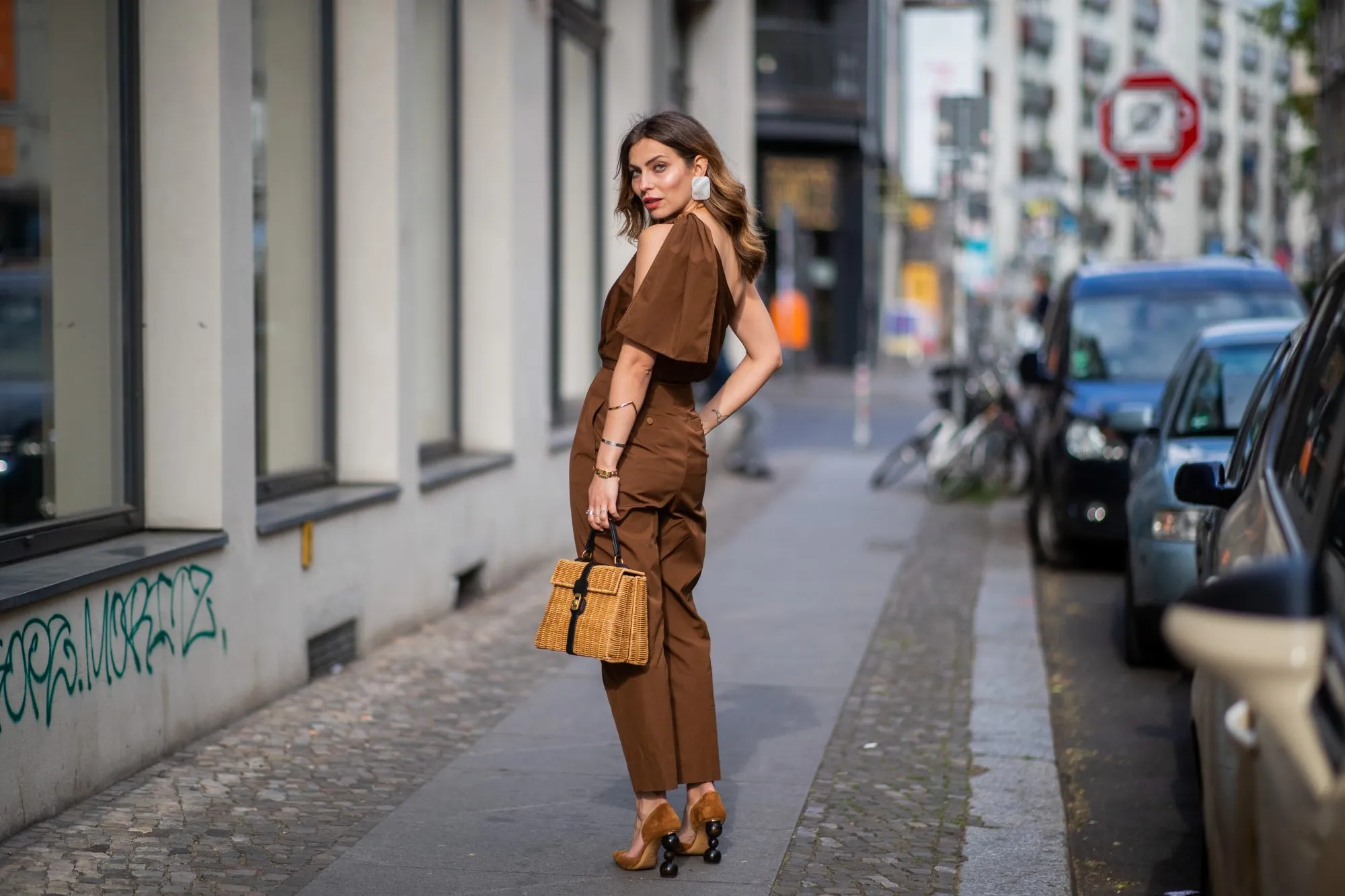 BERLIN, GERMANY - MAY 11: Masha Sedgwick is seen wearing ripped off brown overall Max Mara, clip earrings Mango, Coccinelle straw bag, Jacquemus shoes, on May 11, 2019 in Berlin, Germany. (Photo by Christian Vierig/Getty Images)