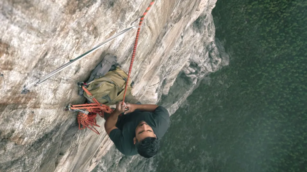 A rock climber over water in Untamed