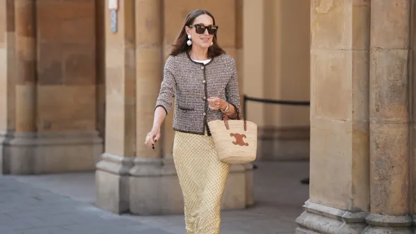 MUNICH, GERMANY - JUNE 18: Annette Weber is seen wearing yellow Allora beaded fitted midi skirt with a mix of glass bugle beads and sequins in a scaly pattern from Veronica Beard; a brown patterned cropped tweed jacket with round neckline, golden buttons and contrasting hem seam from Veronica Beard; a beige hand-braided Teen supple classic panier basket in raffia and cognac brown calfskin with leather logo details and leather straps from CELINE; tortoiseshell oversized square-frame Gaze sunglasses from COS x Linda Farrow; a pair of stud earrings with two large pearls from Manuela Fumagalli; a yellow golden Datejust lady watch from Rolex; a golden statement ring in leave optic with diamond details from Ole Lynggard; a golden ring with „W“-letter detail and further golden rings on June 18, 2025 in Munich, Germany. (Photo by Moritz Scholz/Getty Images)