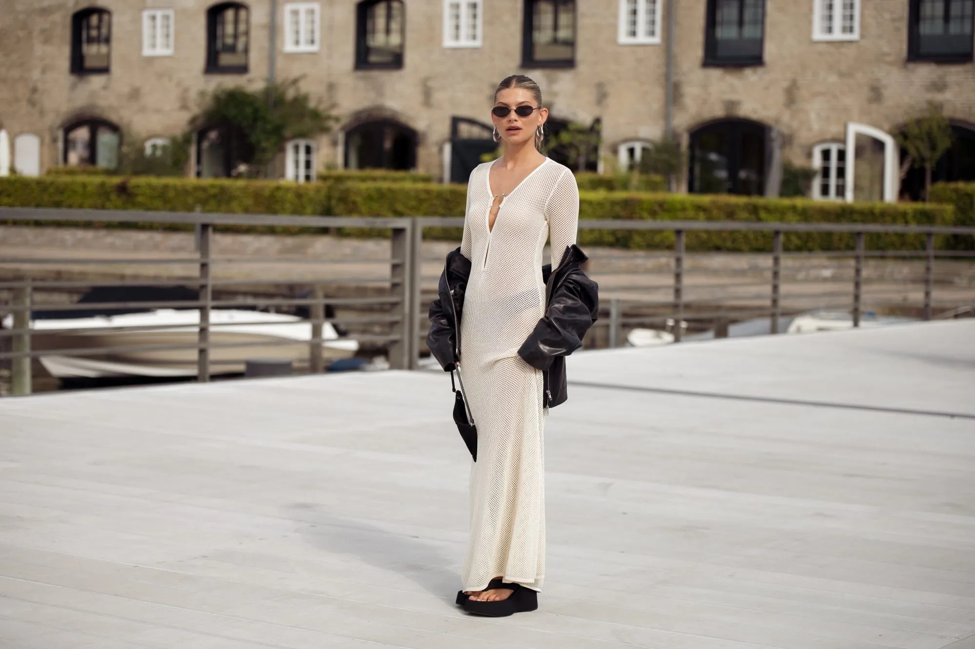 COPENHAGEN, DENMARK - AUGUST 08: Sophia Geiss wears a long beige knitted maxi dress, black flip flops, sandals, leather jacket and black bag during day four of the Copenhagen Fashion Week (CPHFW) SS25 on August 08, 2024 in Copenhagen, Denmark. (Photo by Raimonda Kulikauskiene/Getty Images)