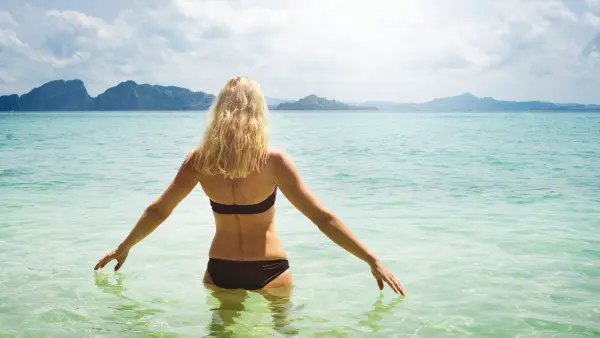 mature woman on holiday, on her way into the ocean, snorkeling, Koh Kradan, Thailand