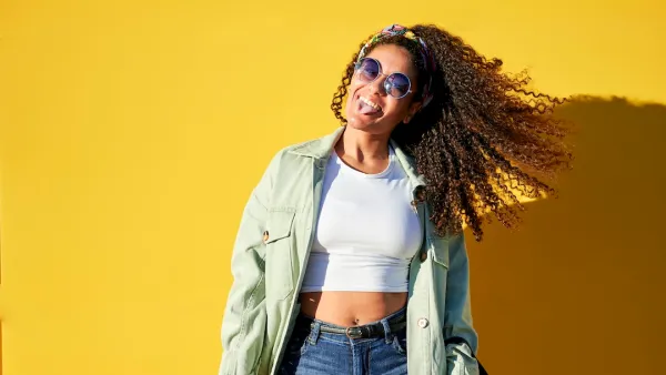 Portrait of woman with sunglasses on yellow background