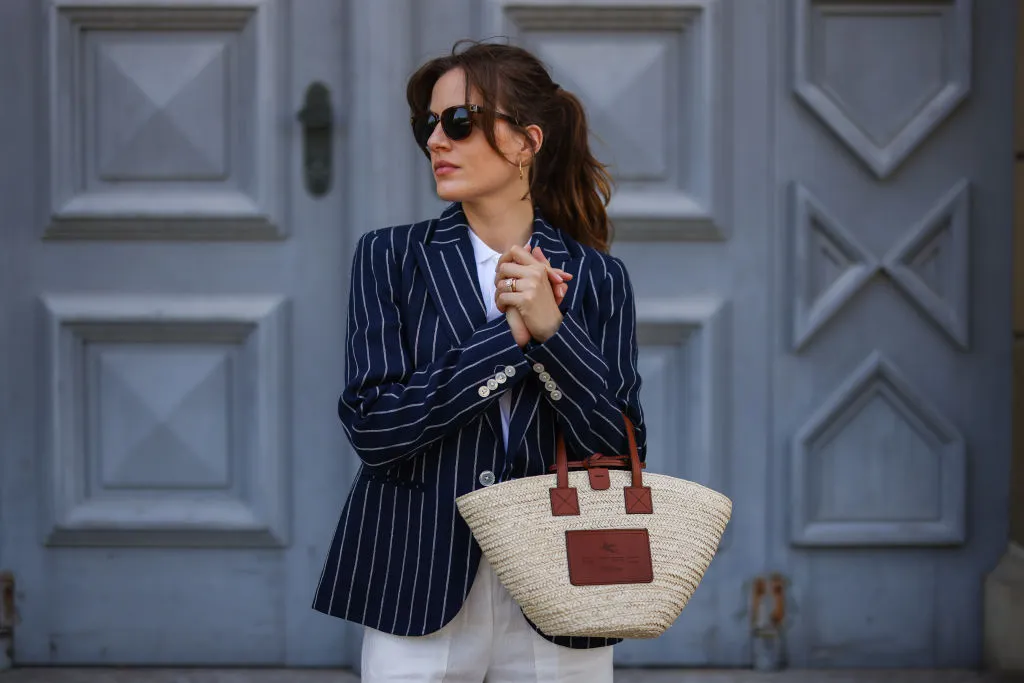 MUNICH, GERMANY - MAY 10: Cleo zu Oettingen-Spielberg wearing navy blue striped Polo Ralph Lauren jacket, white polo and white linen pants and beige Loewe bag via Lodenfrey SS21 on May 10, 2021 in Munich, Germany. (Photo by Jeremy Moeller/Getty Images)