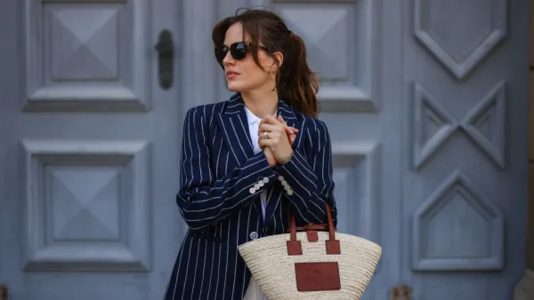 MUNICH, GERMANY - MAY 10: Cleo zu Oettingen-Spielberg wearing navy blue striped Polo Ralph Lauren jacket, white polo and white linen pants and beige Loewe bag via Lodenfrey SS21 on May 10, 2021 in Munich, Germany. (Photo by Jeremy Moeller/Getty Images)