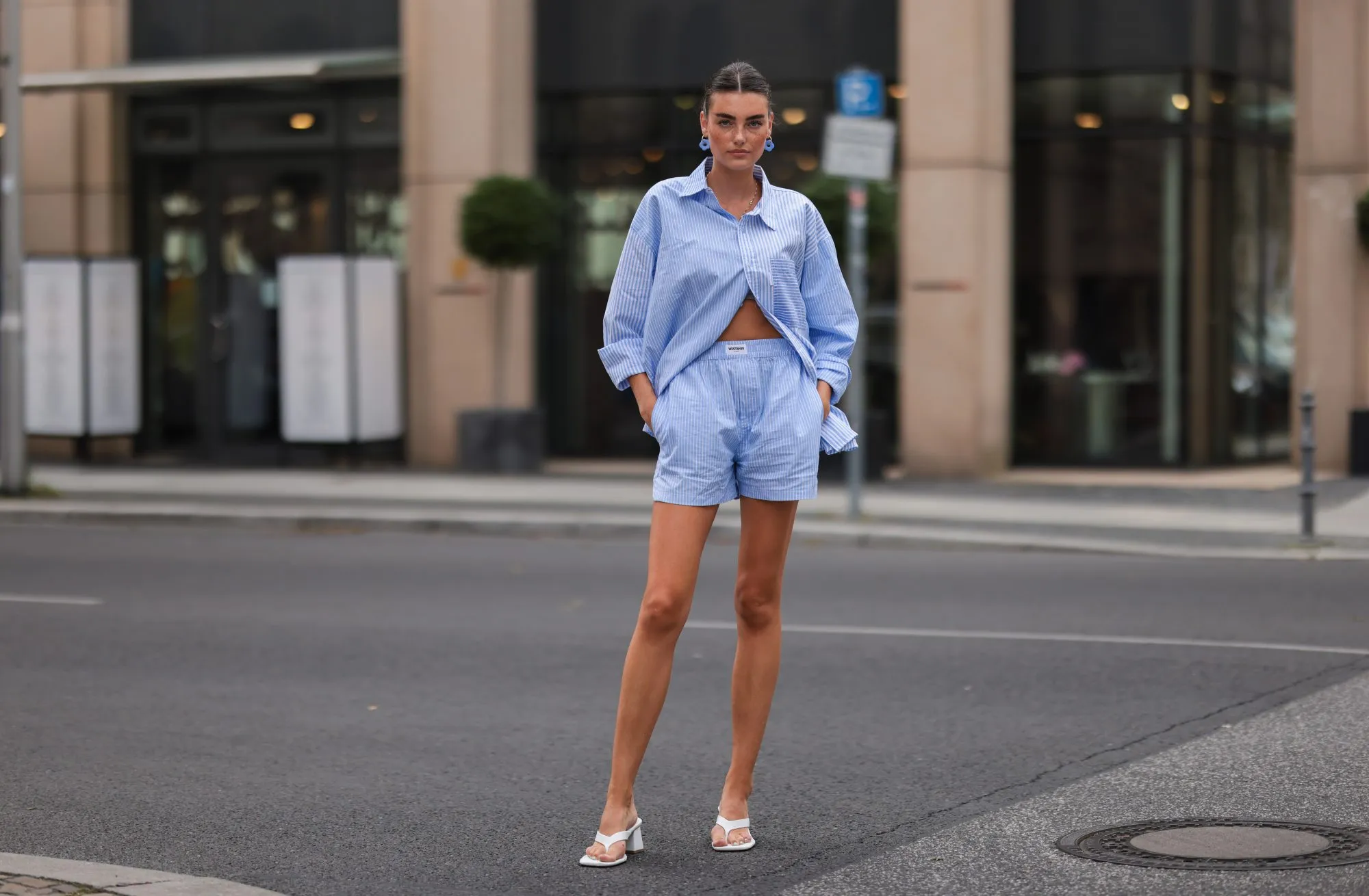 BERLIN, GERMANY - AUGUST 16: Celine Bethmann wearing blue striped Worst Behavior two piece and white Stradivarius heels on August 16, 2021 in Berlin, Germany. (Photo by Jeremy Moeller/Getty Images)