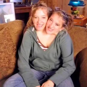 Conjoined Twins Abby and Brittany Hensel Spotted Carrying a Baby Car Seat While Visiting Their Workplace 019