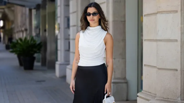 BARCELONA, SPAIN - APRIL 22: Bella Emar is seen wearing white sleeveless Nakd blouse & black skirt, white Jacquemus bag, sunglasses on April 22, 2024 in Barcelona, Spain. (Photo by Christian Vierig/Getty Images)