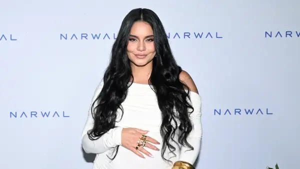 Pregnant Vanessa Hudgens cradling her baby bump at Narwal's summer soiree.