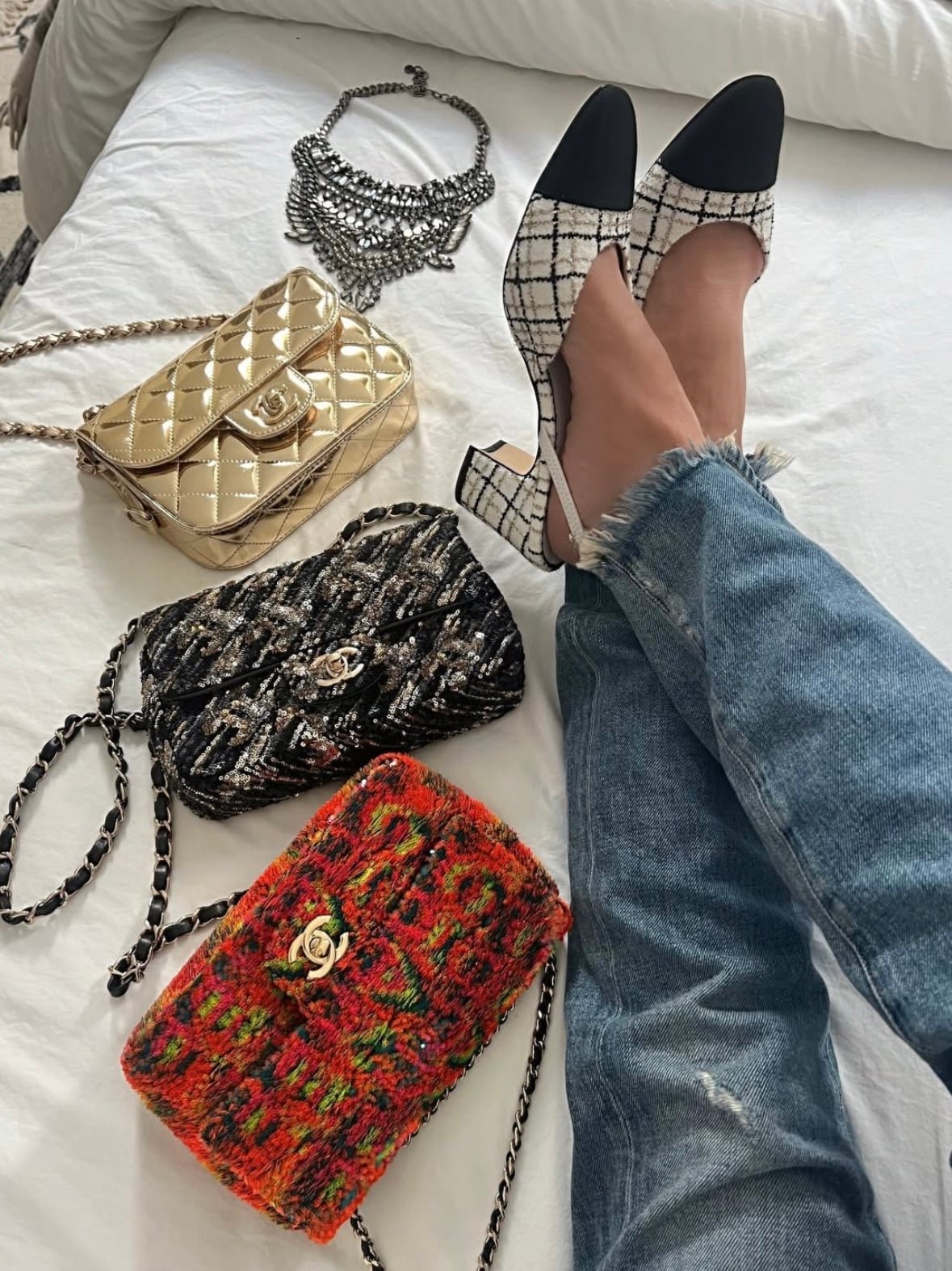 A collectsion of Chanel Classic Flap bag with gold-tone hardware and quilted leather design, displayed on a white background.