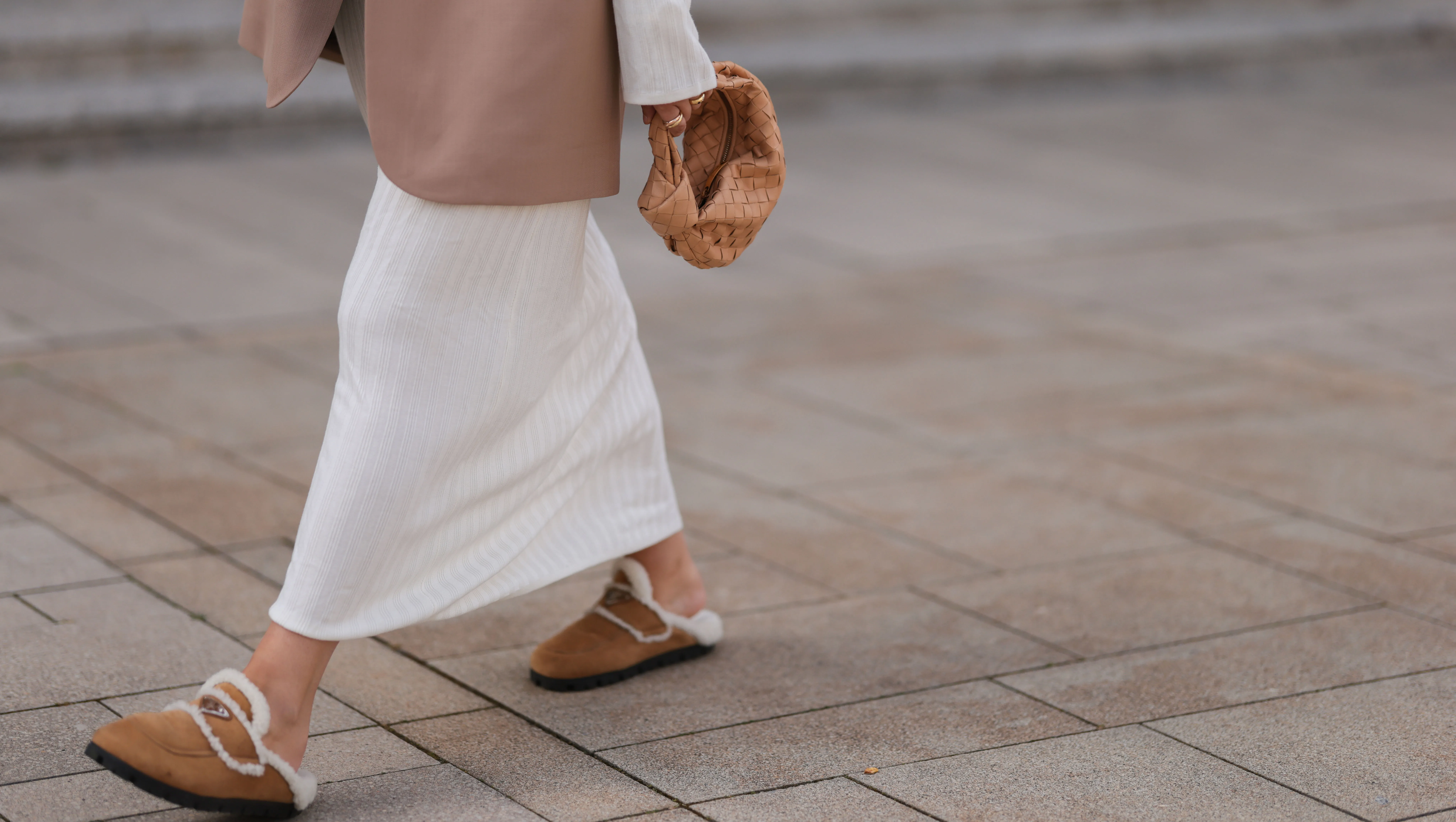 COLOGNE, GERMANY - AUGUST 22: Julia Zwingenberg wearing Christian Dior beige cat eye shades, beige oversized Acne Studios blazer, creme white long by Aylin Koenig dress, Bottega Veneta beige leather mini Jodie bag and Prada beige fur slip shoes on August 22, 2022 in Cologne, Germany. (Photo by Jeremy Moeller/Getty Images)