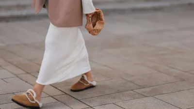 COLOGNE, GERMANY - AUGUST 22: Julia Zwingenberg wearing Christian Dior beige cat eye shades, beige oversized Acne Studios blazer, creme white long by Aylin Koenig dress, Bottega Veneta beige leather mini Jodie bag and Prada beige fur slip shoes on August 22, 2022 in Cologne, Germany. (Photo by Jeremy Moeller/Getty Images)