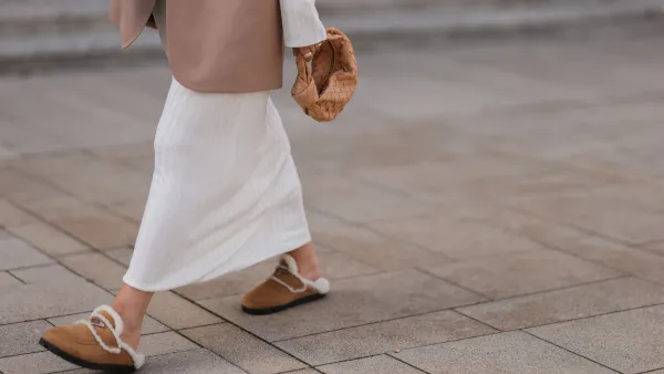 COLOGNE, GERMANY - AUGUST 22: Julia Zwingenberg wearing Christian Dior beige cat eye shades, beige oversized Acne Studios blazer, creme white long by Aylin Koenig dress, Bottega Veneta beige leather mini Jodie bag and Prada beige fur slip shoes on August 22, 2022 in Cologne, Germany. (Photo by Jeremy Moeller/Getty Images)