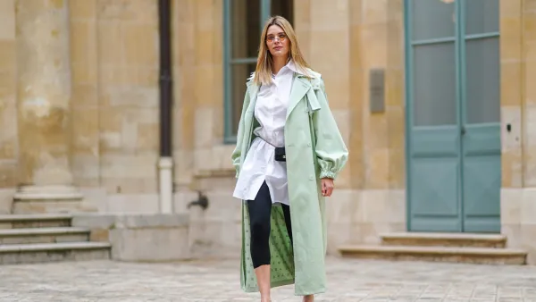 PARIS, FRANCE - MARCH 04: Natalia Verza @mascarada.paris wears sunglasses, a pale pastel mint green long trench coat from Max Mara, a white long shirt, a mini Chanel belt bag, black leggings, white sandals Bling Bling Alzuarr, on March 04, 2021 in Paris, France. (Photo by Edward Berthelot/Getty Images)