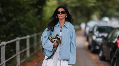 HAMBURG, GERMANY - JULY 27: Semra Hunt wearing Loewe jeans jacket, Fendi baguette and American Vintage white skirt and top on July 27, 2021 in Hamburg, Germany. (Photo by Jeremy Moeller/Getty Images)