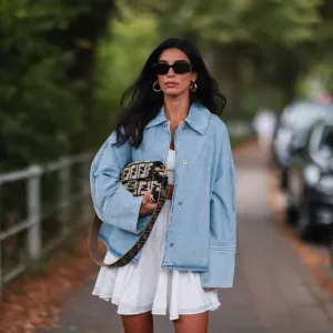 HAMBURG, GERMANY - JULY 27: Semra Hunt wearing Loewe jeans jacket, Fendi baguette and American Vintage white skirt and top on July 27, 2021 in Hamburg, Germany. (Photo by Jeremy Moeller/Getty Images)