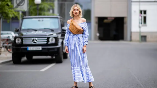 BERLIN, GERMANY - JULY 06: Lisa Hahnbueck wearing striped off shoulder dress Mykke Hofmann, MCM Stark fanny belt bag, Hermes Oran sandals seen during the Berlin Fashion Week July 2018 on July 6, 2018 in Berlin, Germany. (Photo by Christian Vierig/Getty Images)