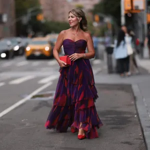 NEW YORK, NEW YORK - SEPTEMBER 07: Olga Ferrara seen wearing Leibish diamond necklace / diamond earrings / diamond bracelet, Hutch pink / purple pattern bandeau pleated long dress, Emanuel Ungaro red leather clutch bag and Scarlett Chase red suede leather pumps / heels, on September 07, 2024 in New York City. (Photo by Jeremy Moeller/Getty Images)
