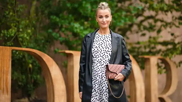 PARIS, FRANCE - SEPTEMBER 24: Noor de Groot wears large earrings, a black leather jacket, a white dress with printed polka dots, a Dior monogram logo bag wears, outside Dior, during Paris Fashion Week - Womenswear Spring Summer 2020, on September 24, 2019 in Paris, France. (Photo by Edward Berthelot/Getty Images)